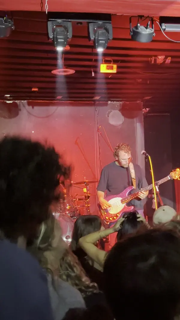 DogPaw on stage under red light at the band's first show