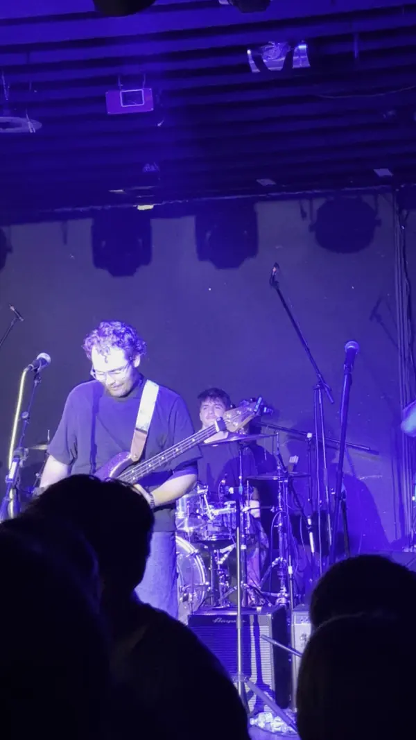DogPaw singing under blue light at the band's first show