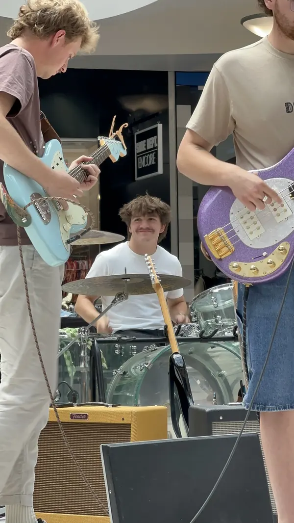 DogPaw bandmates framing the drummer at the Provo Farmers Market