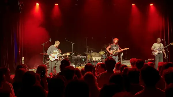 Wide shot of DogPaw on The Depot stage under red lights