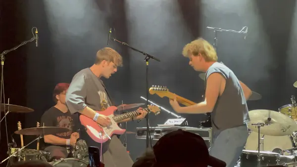 DogPaw bandmates facing off in a white spotlight at The Depot