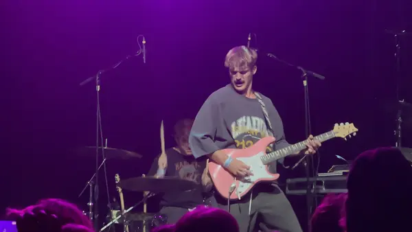 DogPaw guitarist under purple stage lights at The Depot