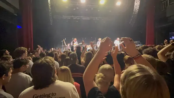 Fans with hands up during DogPaw's set at The Depot