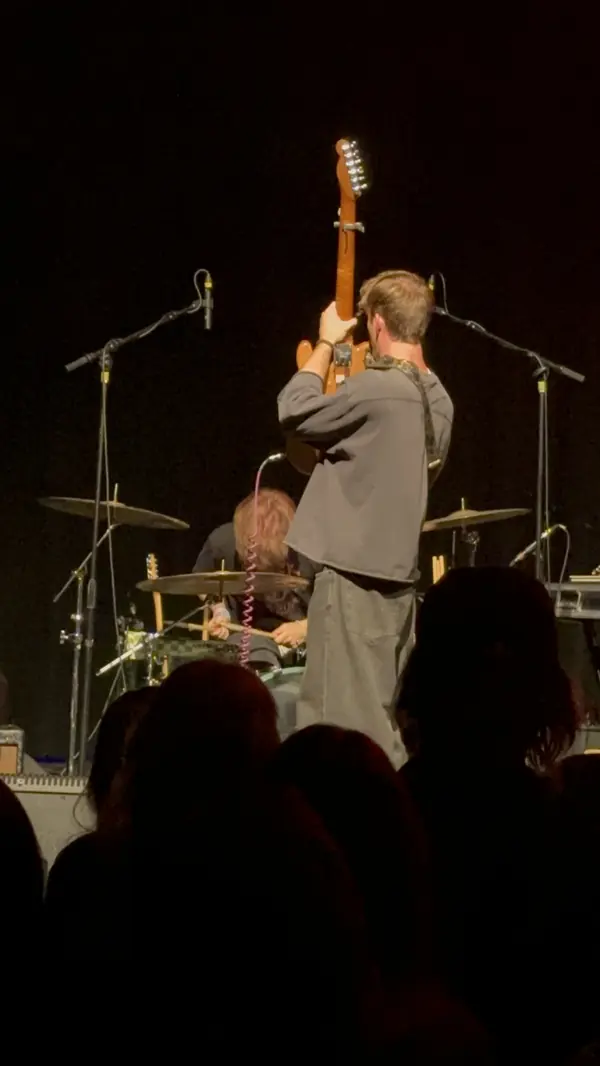 DogPaw guitarist raising his guitar at the end of the set at The Depot